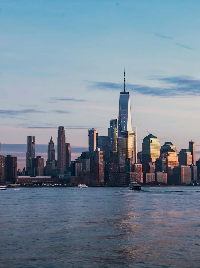 Lower Manhattan seen across the harbour at last light.
