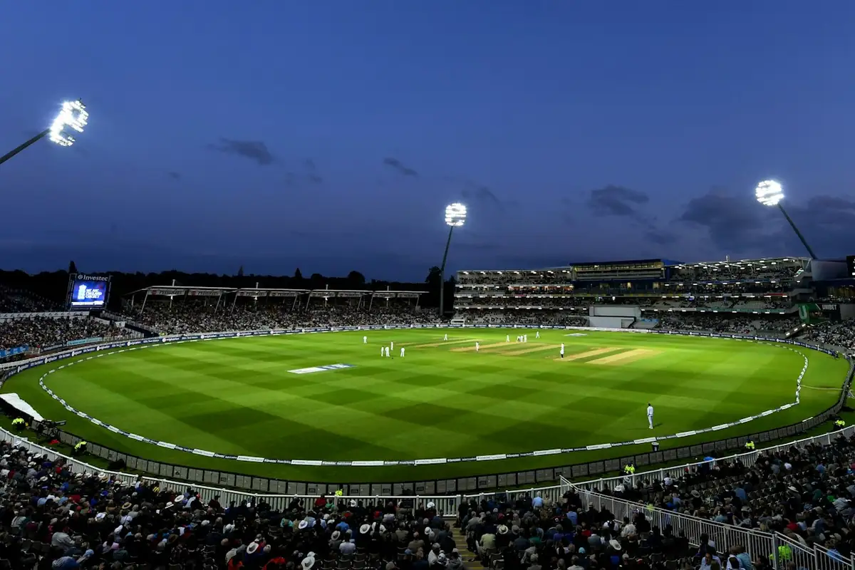 Floodlit stadium bowl on a clear night.